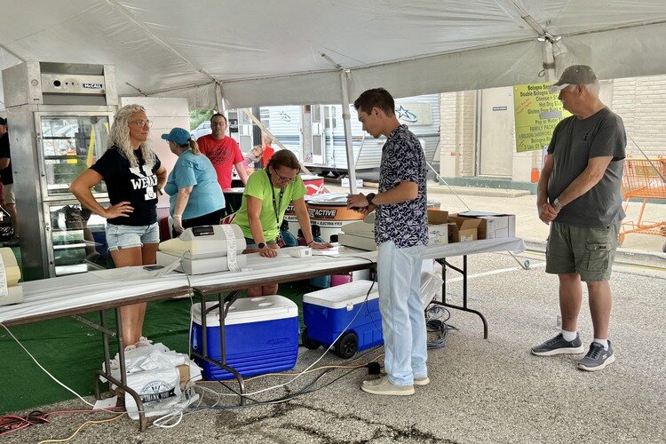 People ordering C. Roy bologna sandwiches at the food tent at the Yale Bologna Festival.