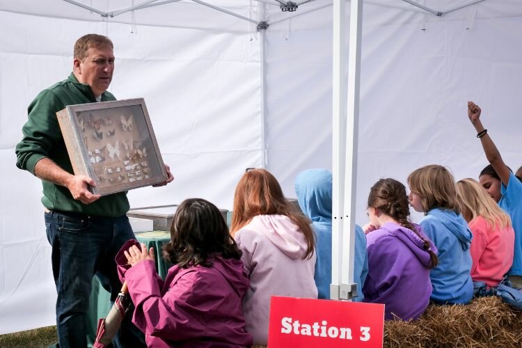 Fourth graders listen to Brian Gardner, agriculture program coordinator at Montcalm Community College, who talked about bugs.