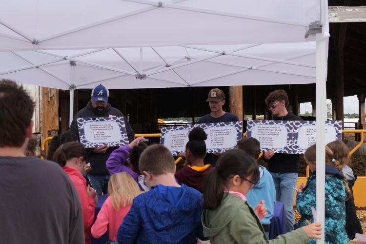 Pasch Dairy Farms taught students fun cow facts—such as how many gallons of water cows drink each day.