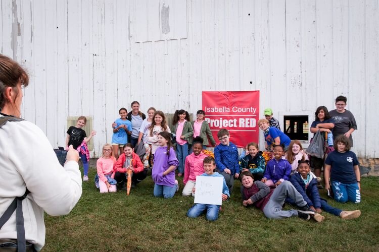Fourth grade teacher Missy Groves poses with her classroom for a photo.