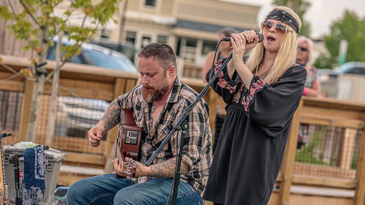 Jennifer Westwood and Dylan Dunbar perform outdoors.