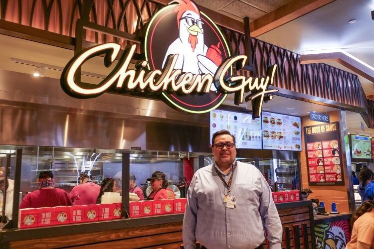 Raul Venegas, executive director of marketing, entertainment & sales at Soaring Eagle Casino & Resort/Eagles Landing Casino & Hotel in front of the new Chicken Guy! Photo Credit: Courtney Jerome / Epicenter Mt. Pleasant