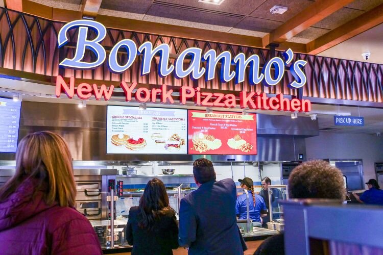 Visitors at the ribbon cutting ceremony check out the menu of Bonanno’s New York Pizzeria in the Soaring Eagle Casino. Photo Credit: Courtney Jerome / Epicenter Mt. Pleasant 