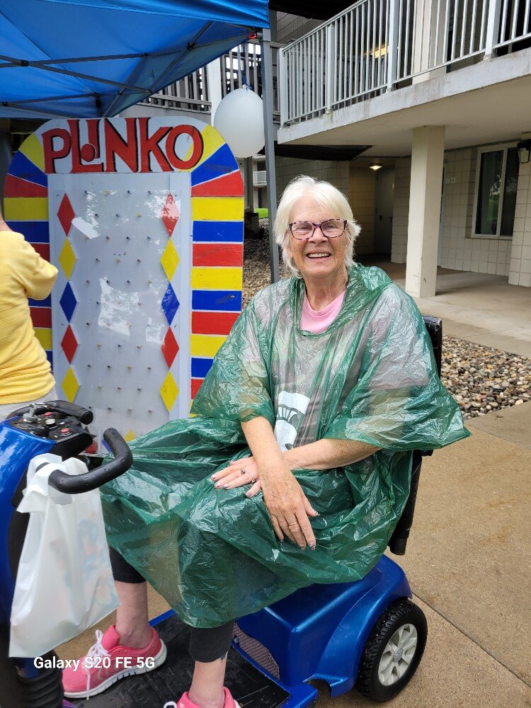 Cleveland Manor resident Ellen Jerry loves the remodeling of the senior apartments, especially the walk-in showers. She fended off the rain at the Open House/Carnival on July 12, celebrating the work. 