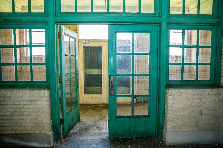 Cameras and a fence around the exterior have protected the interior from damage. Interior offices lined with windows still exist inside the building.