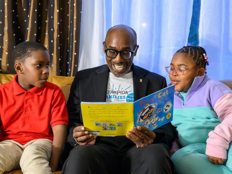 James Ribbron reads to Dwayne Sharpe and Elizabeth Brooks.