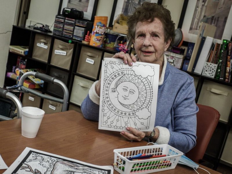 A LifeCircles PACE participant shows off their coloring. LifeCircles provides a day center and encourages participants to attend for socialization.
