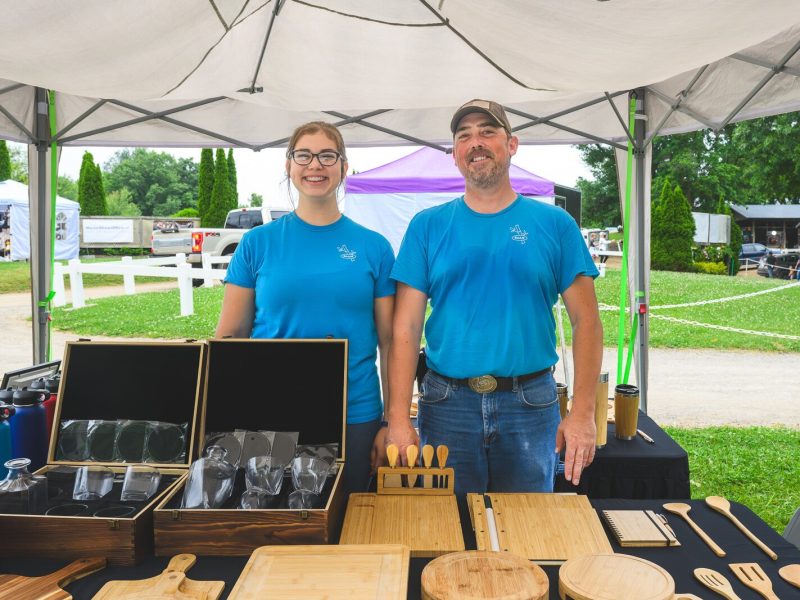 Annalies Walsh and her father Joe Walsh selling Manchester Entrepreneurial STEM merchandise at Waterloo Hunt Club in Grass Lake.