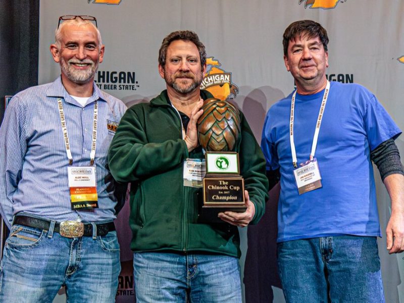 2025 Chinook Cup Winner: Dog Star Hops. Pictured (l-r) Alec Mull, Bell’s Brewery, presents the award to Ken Porter and Jim Mikesell of Dog Star Hops, Charlotte.