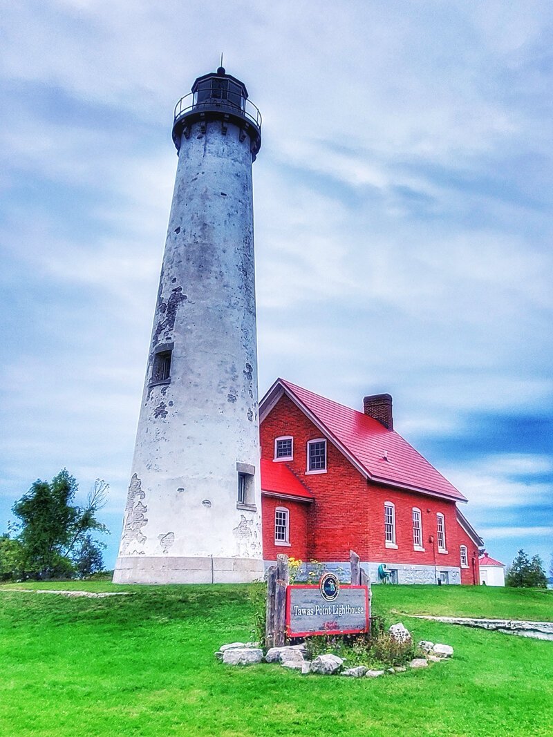 Previous restoration had covered the brick tower in a cement coating called parge. By 2020, the parge had failed along the tower, damaging original brick. (Credit: Ana Eastlick, 2020 Michigan State Parks photo ambassador)