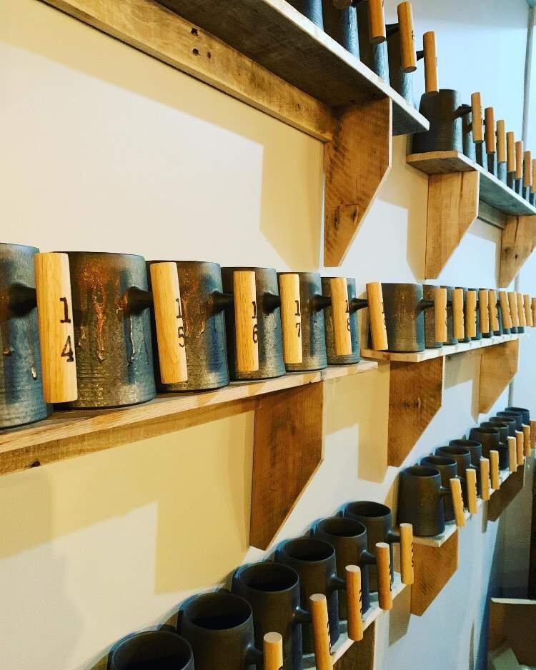 Shelves have been built to display Founders Club mugs.