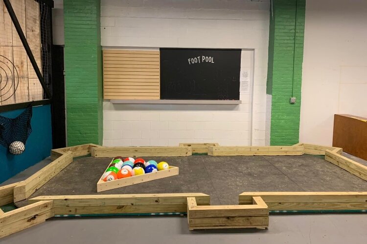 Foot Pool challenges players to use their feet in place of pool cues. Giant balls replace the pool balls. (Photo courtesy of Reality Check)