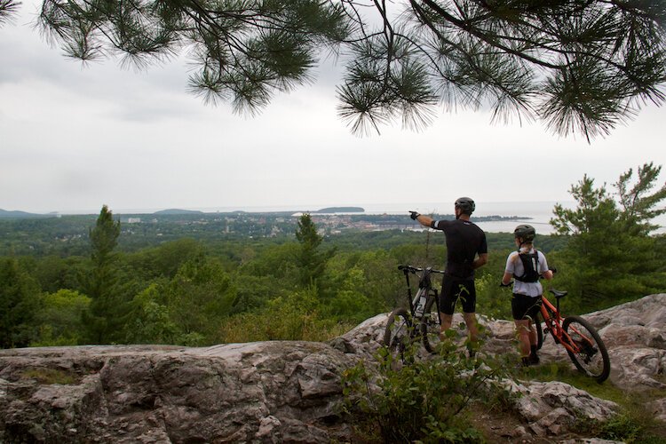 Bikers take in the views from Mount Marquette.