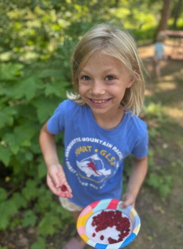 Harriet Nyberg shows off freshly picked thimbleberries.