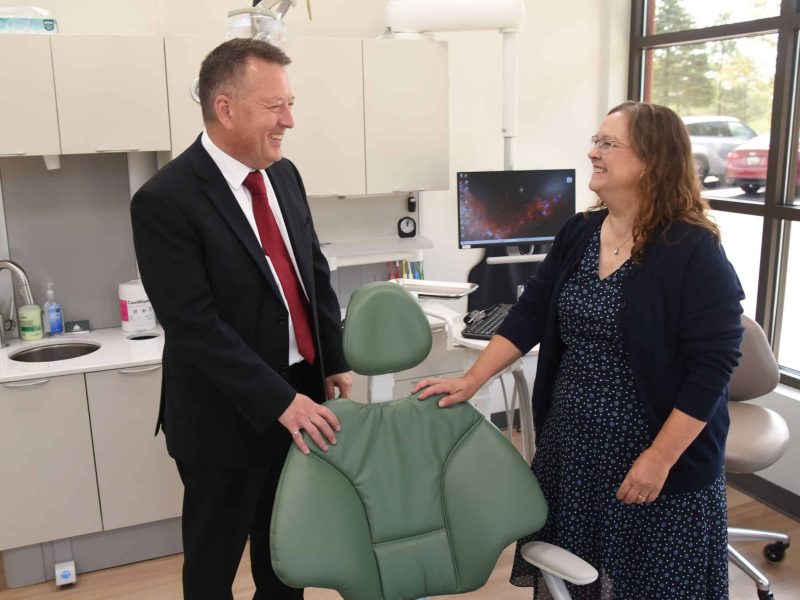 Dr. David Finley, president of North Central Michigan College (NCMC), and Rico Breznau, director of NCMC's dental hygiene program, chat at Northern Periodontics & Implant Dentistry in Petoskey.